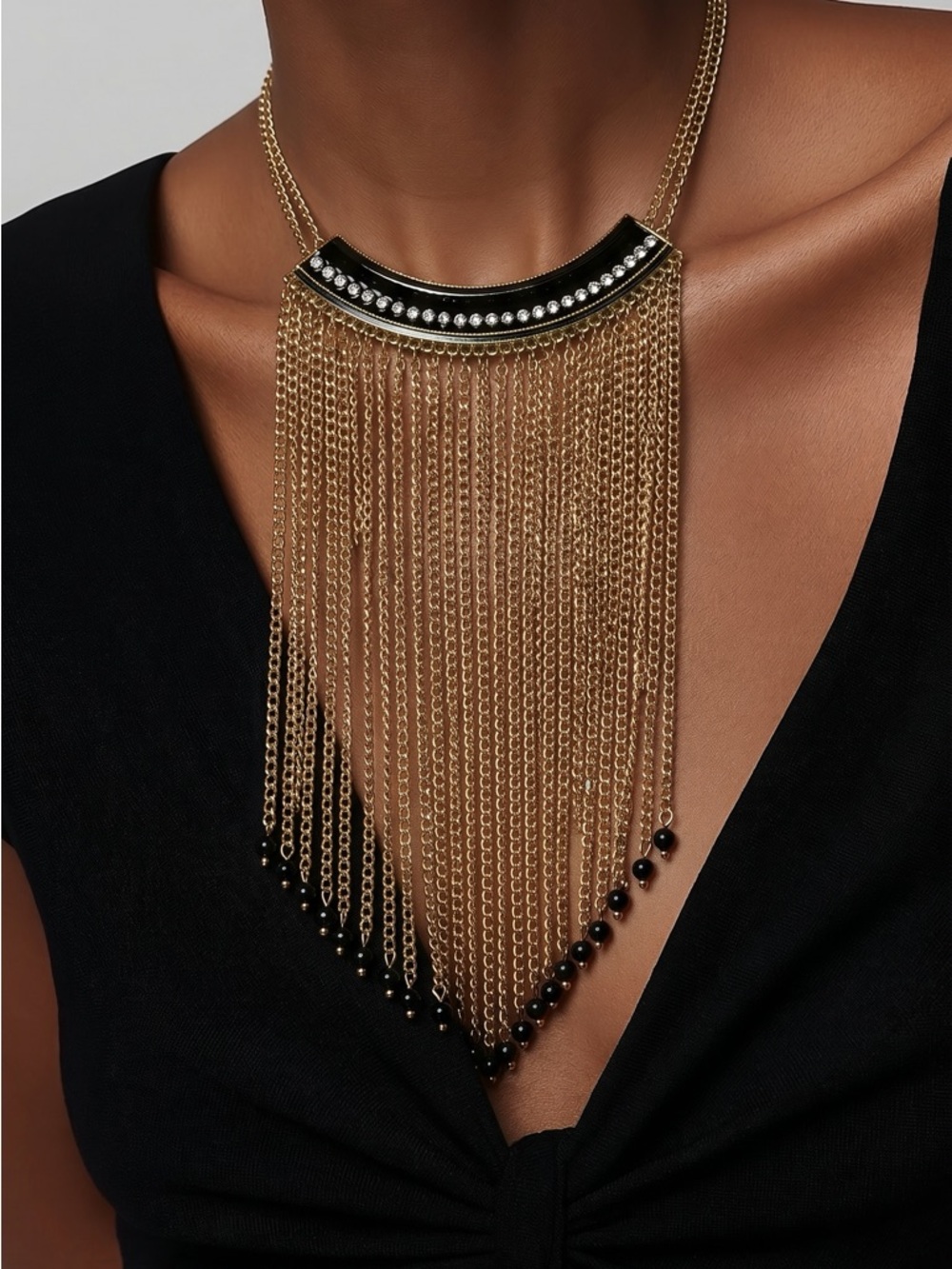 Gold tone long fringe necklace! Black and rhinestone accents!